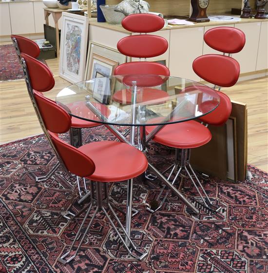 A stylish chromed metal dining table with circular glass top, and a set of four revolving chairs